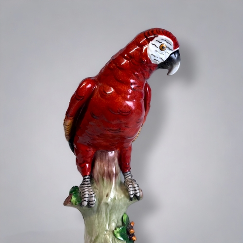 312 - A SITZENDORF PORCELAIN PARROT FIGURINE.
'Scarlet Macaw'
Sitzendorf, Thuringia, C1920.
Height - 23.5c... 