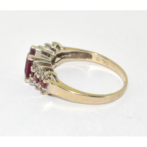 434 - 14ct gold ladies Diamond and Ruby ring set with a emerald cut Ruby centre stone size P