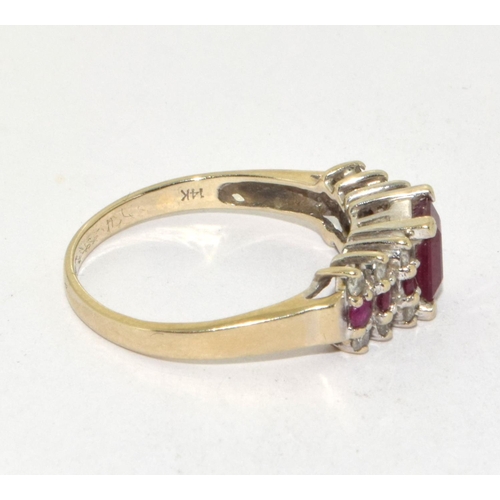 434 - 14ct gold ladies Diamond and Ruby ring set with a emerald cut Ruby centre stone size P