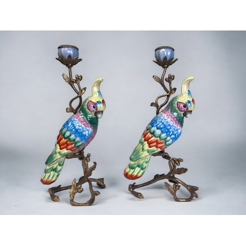 337 - A PAIR OF LARGE HANDPAINTED CERAMIC PARROTS CANDLESTICKS.
Gilt metal mounted in a Acorn & leaf desig... 