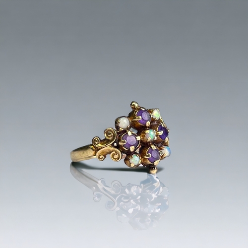 390 - ANTIQUE ARTS & CRAFTS 9CT GOLD, OPAL AND AMETHYST RING.
Fancy setting, set with five round opals and... 