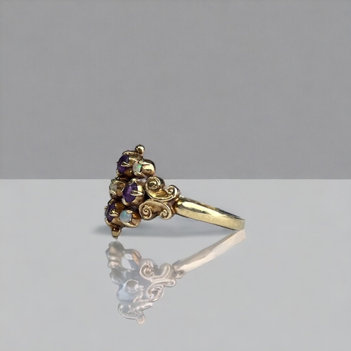 390 - ANTIQUE ARTS & CRAFTS 9CT GOLD, OPAL AND AMETHYST RING.
Fancy setting, set with five round opals and... 