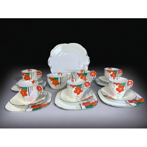 338 - AN ART DECO HAND PAINTED PART TEASET.
Hand painted floral pattern with 'flower' handles.
Includes, f... 