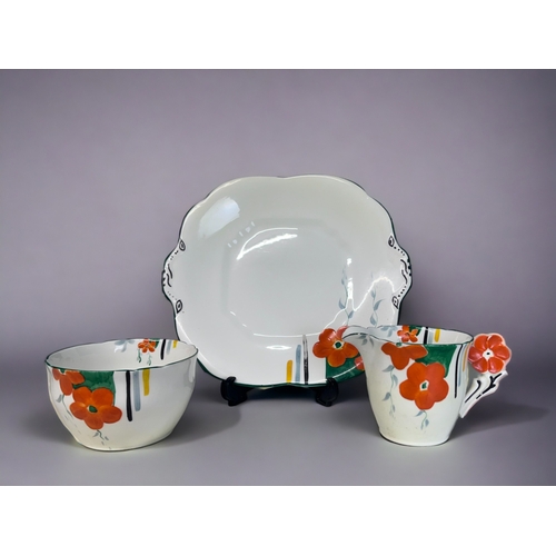 338 - AN ART DECO HAND PAINTED PART TEASET.
Hand painted floral pattern with 'flower' handles.
Includes, f... 