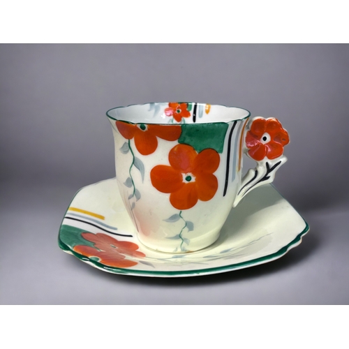 338 - AN ART DECO HAND PAINTED PART TEASET.
Hand painted floral pattern with 'flower' handles.
Includes, f... 