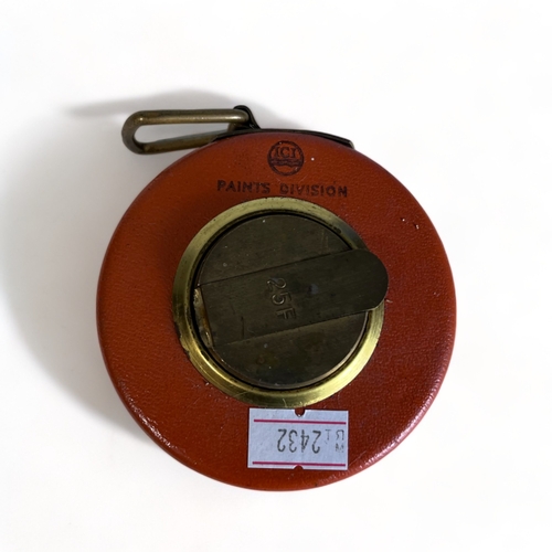 334 - Two vintage tape measures, together with a pair of Rand opera binoculars.