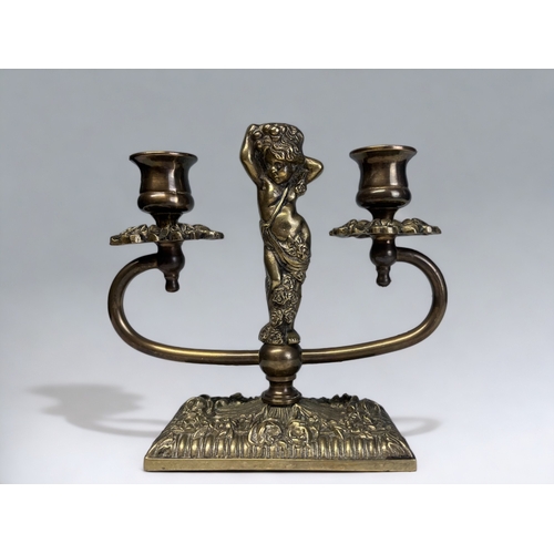 342 - A vintage brass twin-branch figural candlestick. 18 x 19cm