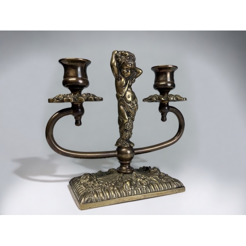 342 - A vintage brass twin-branch figural candlestick. 18 x 19cm