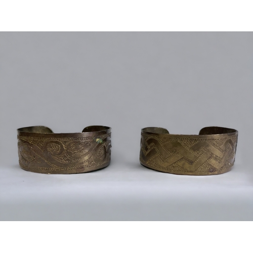 343 - Two 1970's tribal engraved brass cuff bracelets.