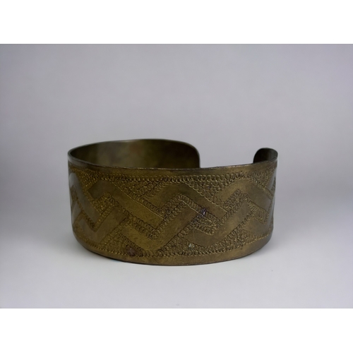 343 - Two 1970's tribal engraved brass cuff bracelets.