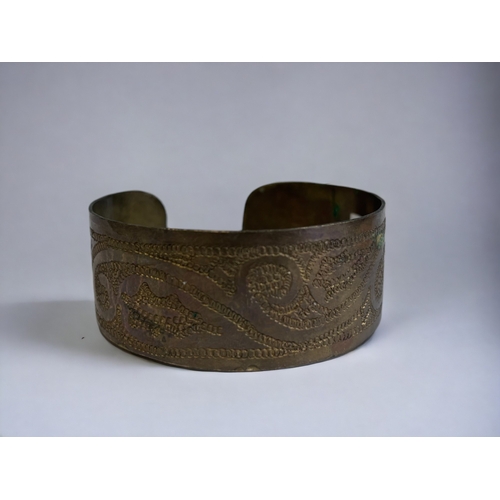 343 - Two 1970's tribal engraved brass cuff bracelets.