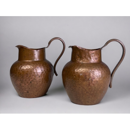 345 - A Pair of Arts & Crafts Style Copper Milk Jugs. 
Marked to base.