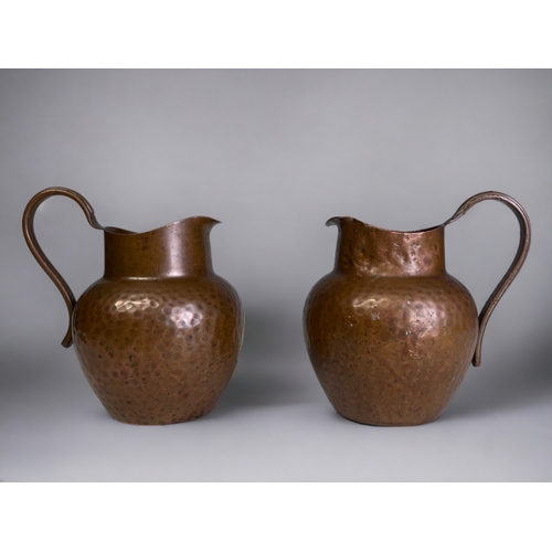 345 - A Pair of Arts & Crafts Style Copper Milk Jugs. 
Marked to base.