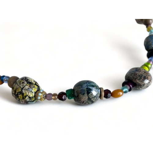 354 - A Large Cornwall Seashore Pebble & Glass Necklace & Bracelet.
Depicting numerous hand-painted pebble... 