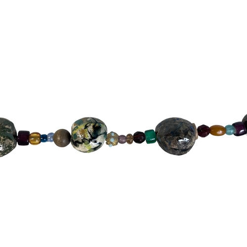 354 - A Large Cornwall Seashore Pebble & Glass Necklace & Bracelet.
Depicting numerous hand-painted pebble... 