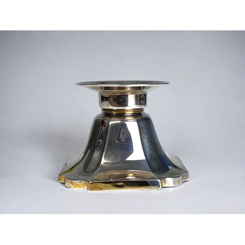 359 - A Sterling Silver Tealight Candlestick.
Wide, weighted tapering base.
With remnants of gilding.
7 x ... 