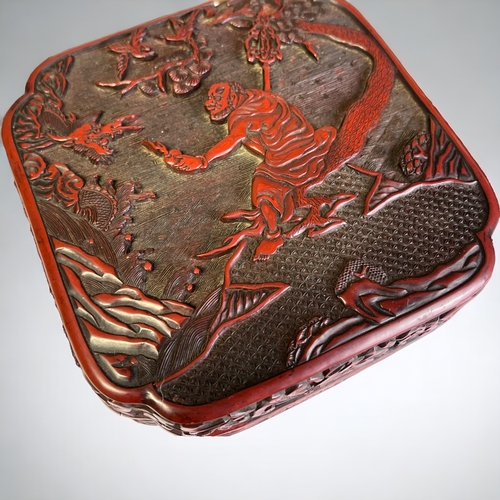 24 - A DEEPLY CARVED CHINESE CINNABAR BOX.
18th/19th Century.
Carved, unusual with an Immortal of Dragon ... 