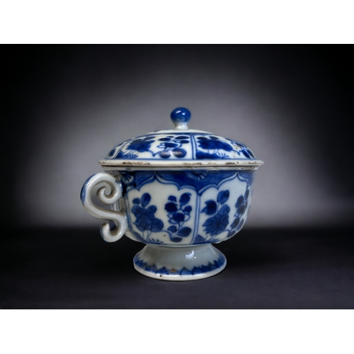 32 - A CHINESE BLUE & WHITE PORCELAIN TWIN HANDLE CUP.
Kangxi period (1661-1722).
On raised foot, with pa... 