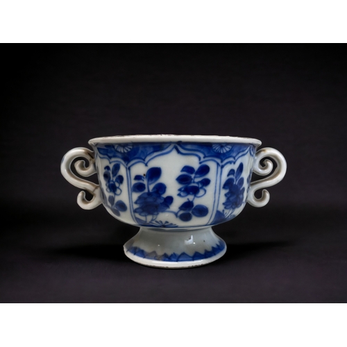 32 - A CHINESE BLUE & WHITE PORCELAIN TWIN HANDLE CUP.
Kangxi period (1661-1722).
On raised foot, with pa... 