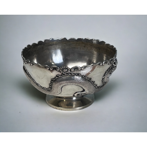 40 - A CHINESE SILVER DRAGON BOWL.
Early 20th Century.
By Sing Fat, Shanghai.
Embossed with a finely deta... 