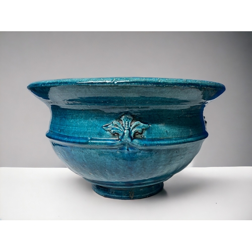 344 - A LARGE ART NEAUVEAU PLANTER.
Circa 1900.
Stoneware, with a turquoise Majolica glaze and fleur-de-li... 