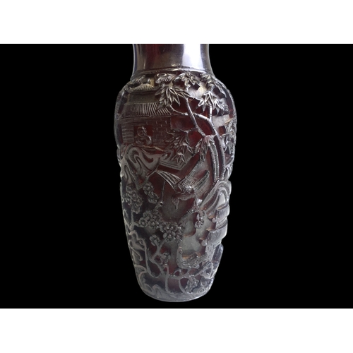 63 - A Chinese deep carved Cherry Amber vase. 
Qing dynasty.
Elaborately carved with landscape scenes, de... 