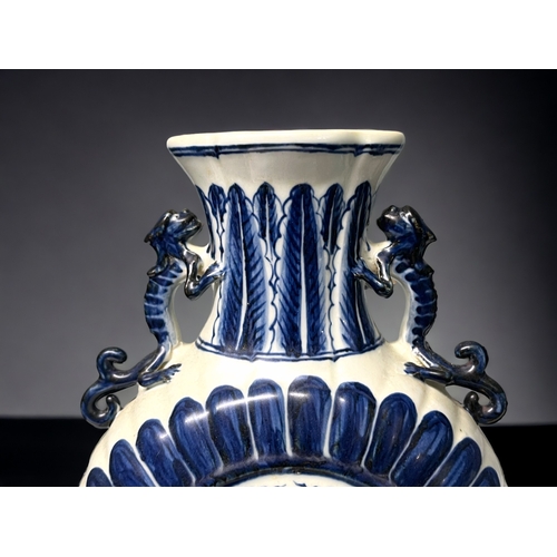 77 - A Chinese blue & white porcelain moon flask. Depicting double Phoenix amongst the clouds. Stylis... 