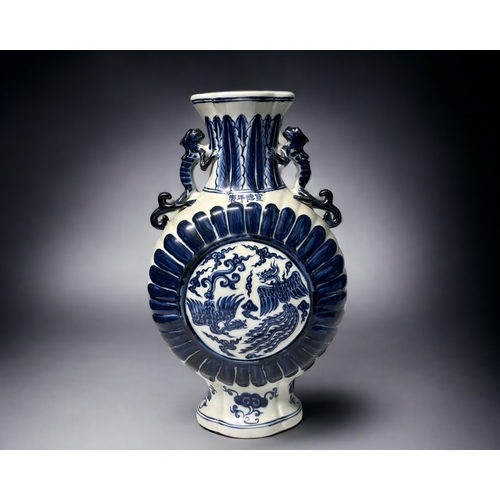 77 - A Chinese blue & white porcelain moon flask. Depicting double Phoenix amongst the clouds. Stylis... 