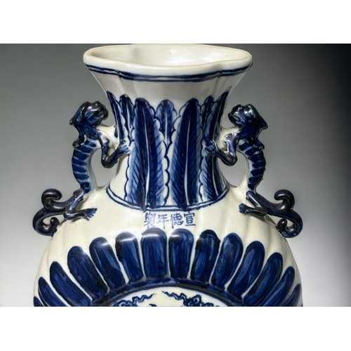 77 - A Chinese blue & white porcelain moon flask. Depicting double Phoenix amongst the clouds. Stylis... 