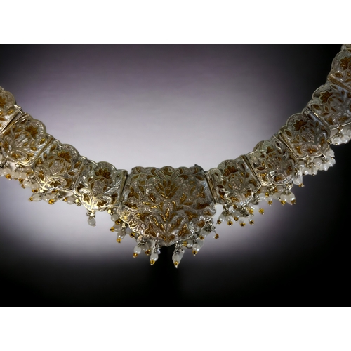 394 - A PERSIAN? WHITE & GILT METAL ENAMELLED CHOKER NECKLACE.
Stylised foliate design, with drop pearls &... 