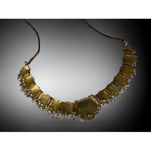 394 - A PERSIAN? WHITE & GILT METAL ENAMELLED CHOKER NECKLACE.
Stylised foliate design, with drop pearls &... 