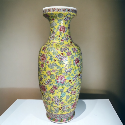 97 - A LARGE CHINESE PORCELAIN FAMILLE ROSE FLOOR VASE.
Yellow ground, with painted overglaze enamels flo... 