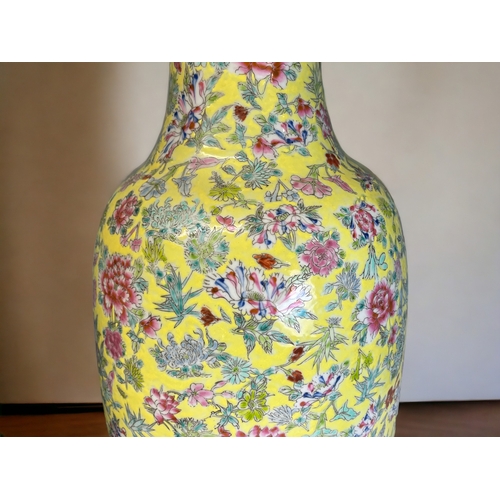 97 - A LARGE CHINESE PORCELAIN FAMILLE ROSE FLOOR VASE.
Yellow ground, with painted overglaze enamels flo... 