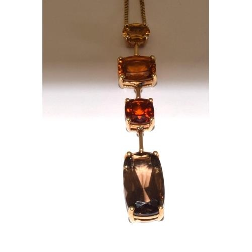 426 - An elegant 9ct gold pendant necklace of semi precious stones in pleasing autumnal colours together w... 