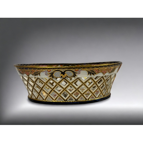 404 - A 19th Century English porcelain 'Imari' chestnut basket.
Reticulated sides. 
Leaf marks to base.