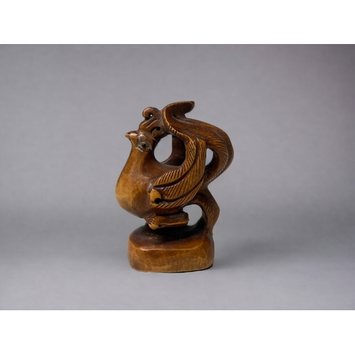 92 - Two carved Japanese Netsuke's.
20th century.
One Phoenix, signed to base. Together with a Dragon-tur... 