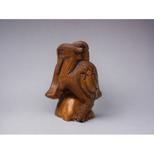 93 - A Japanese carved Netsuke.
20th century.
Depicting a pair of Pelicans. Signed to base.