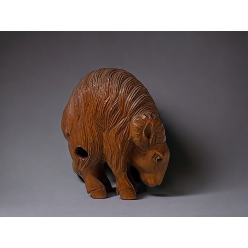 94 - A Japanese carved Netsuke.
20th century.
Depicting a Goat, with high arched back. 
Signed to hind le... 