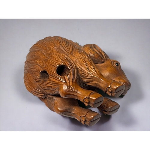 94 - A Japanese carved Netsuke.
20th century.
Depicting a Goat, with high arched back. 
Signed to hind le... 