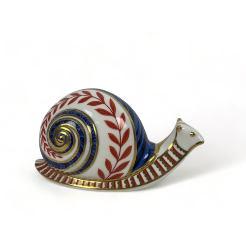 409 - Two Royal Crown Derby paperweights.
Including a snail & partridge.