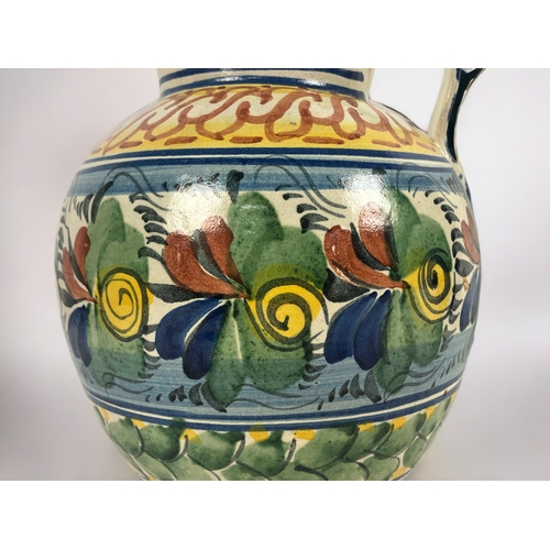 411 - A large Continental Maiolica jug. 
18th / 19th century.
Hand painted foliate design. Unmarked.
Heigh... 