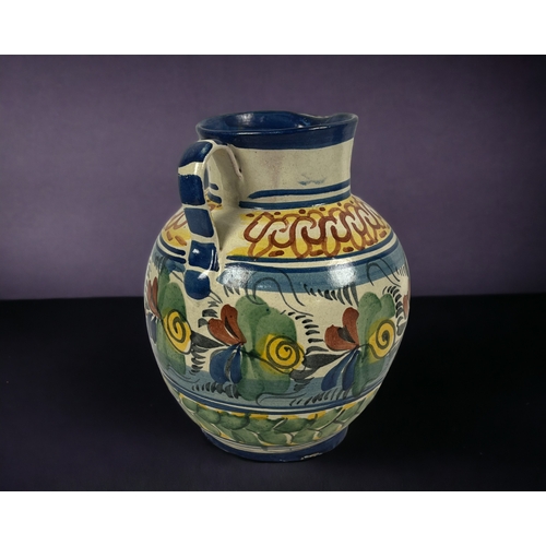 411 - A large Continental Maiolica jug. 
18th / 19th century.
Hand painted foliate design. Unmarked.
Heigh... 