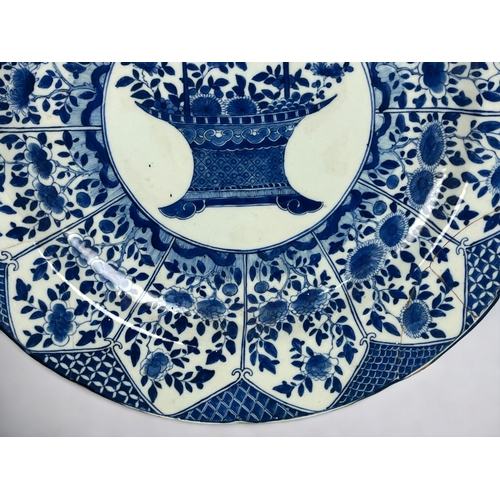 103 - A large Chinese porcelain 'Flower basket' blue & white charger Qing dynasty, Kangxi period.