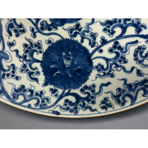 104 - A large Chinese porcelain blue & white charger. Qing dynasty, Kangxi period. Painted Lotus flowe... 