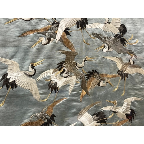 115 - A fine quality Japanese school Silk tapestry panel.
Meiji period.
Depicting numerous Cranes, on blue... 