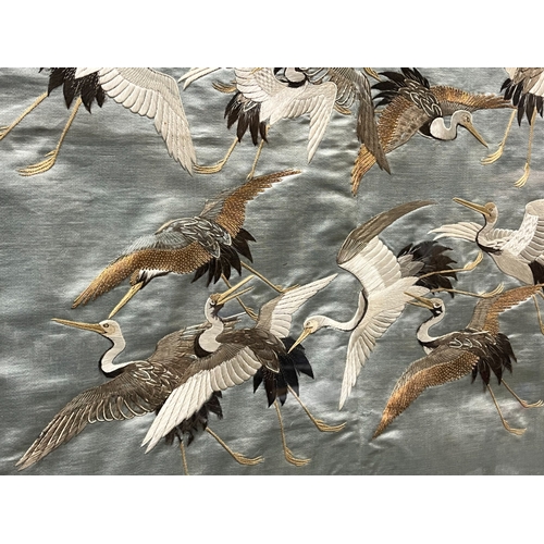 115 - A fine quality Japanese school Silk tapestry panel.
Meiji period.
Depicting numerous Cranes, on blue... 