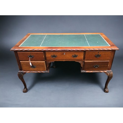 258 - A 20th Century Mahogany Desk, with dragoon edging, cabriole legs with ball and claw feet. Green leat... 