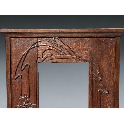 259 - Art Nouveau carved oak wall mirror. 
Bevel edged mirror and carved foliate design wall shelf.