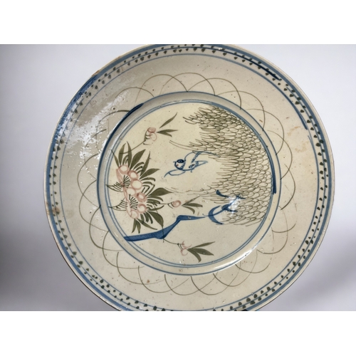 126 - A pair of 19th century Chinese plates. 
Hand painted with flying birds blossoming flowers below a Wi... 