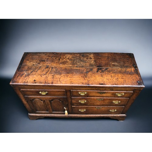 289 - AN early 18th century Oak side cupboard.
Plank top above four drawers and arched door. On bracket fe... 